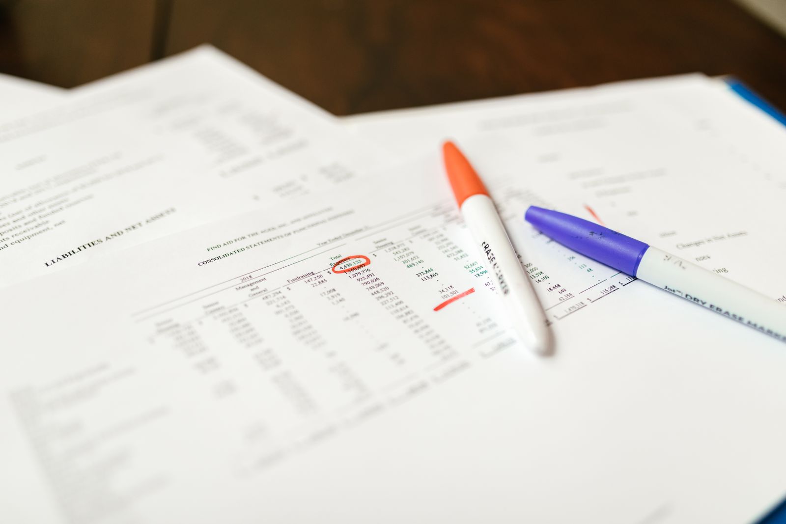 A person comparing two resume layouts side by side on a laptop screen, one single-column and one with a colored sidebar