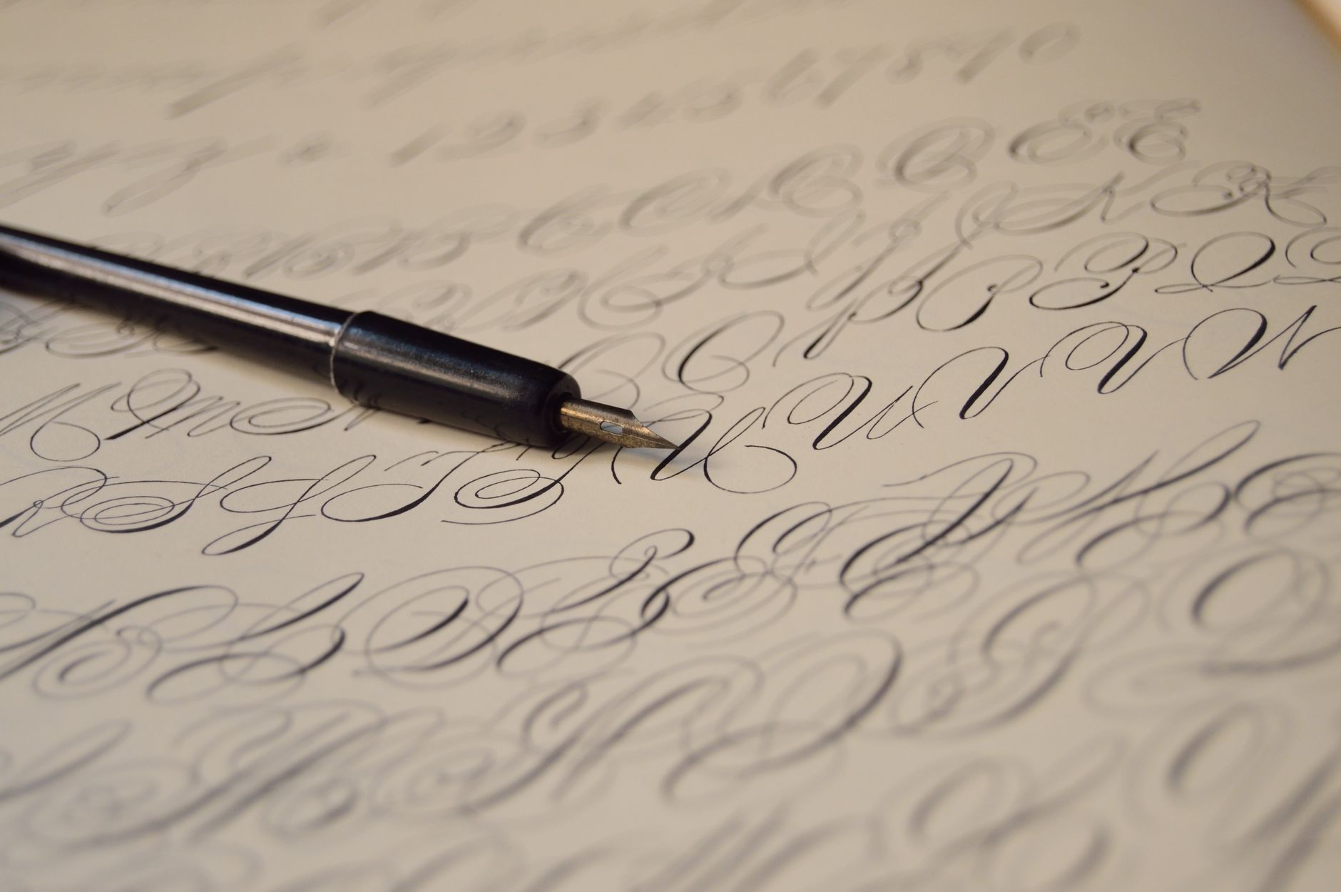 A fountain pen resting on printed paper, representing cover letter writing