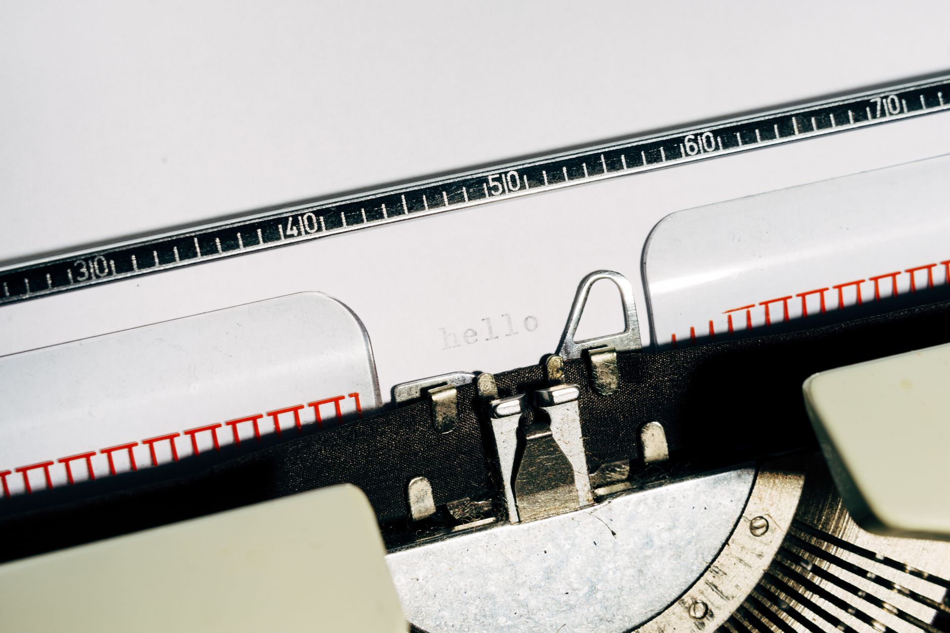 A sheet of white paper rolled into a vintage typewriter, representing letter writing