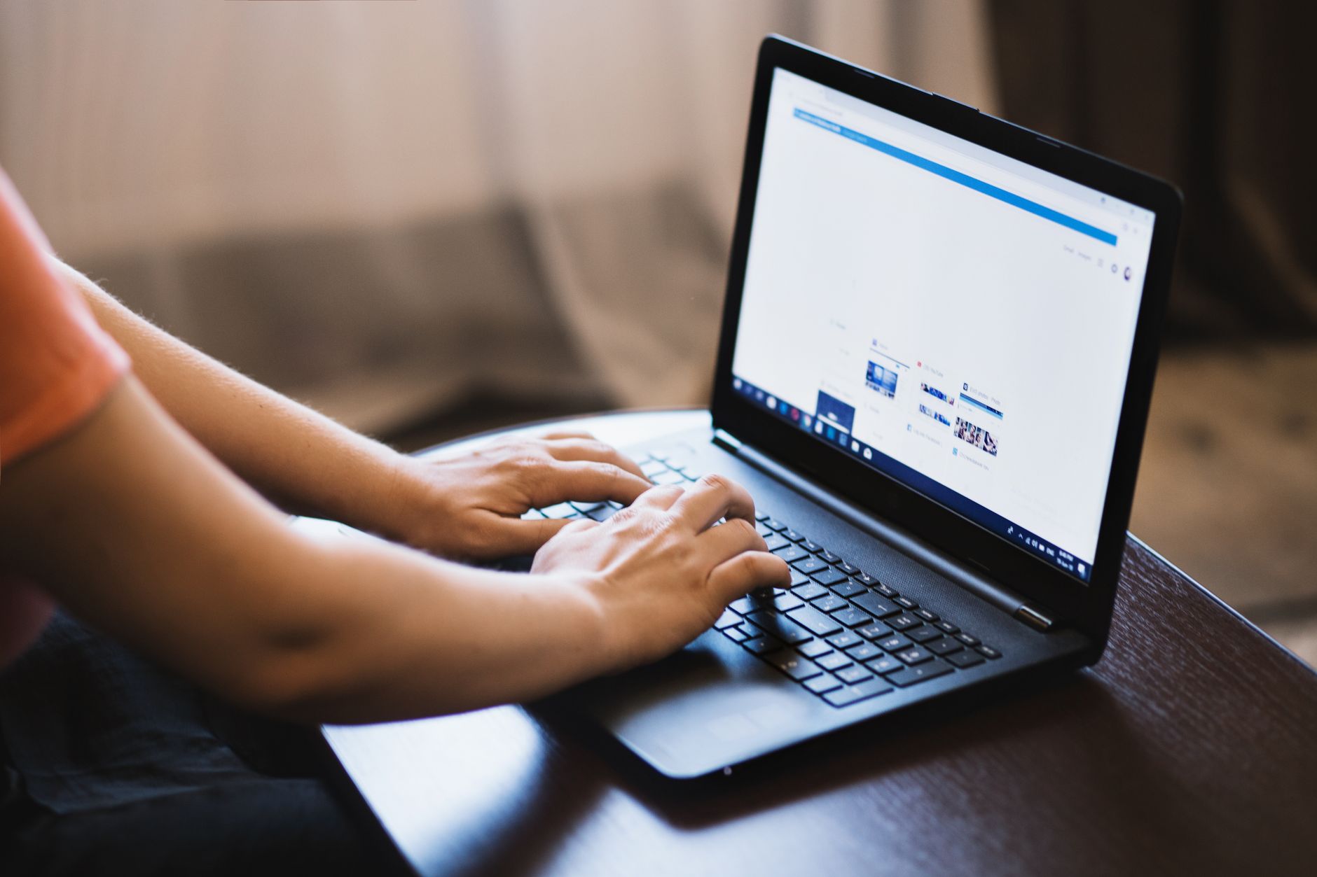 A person typing on a laptop while searching for jobs