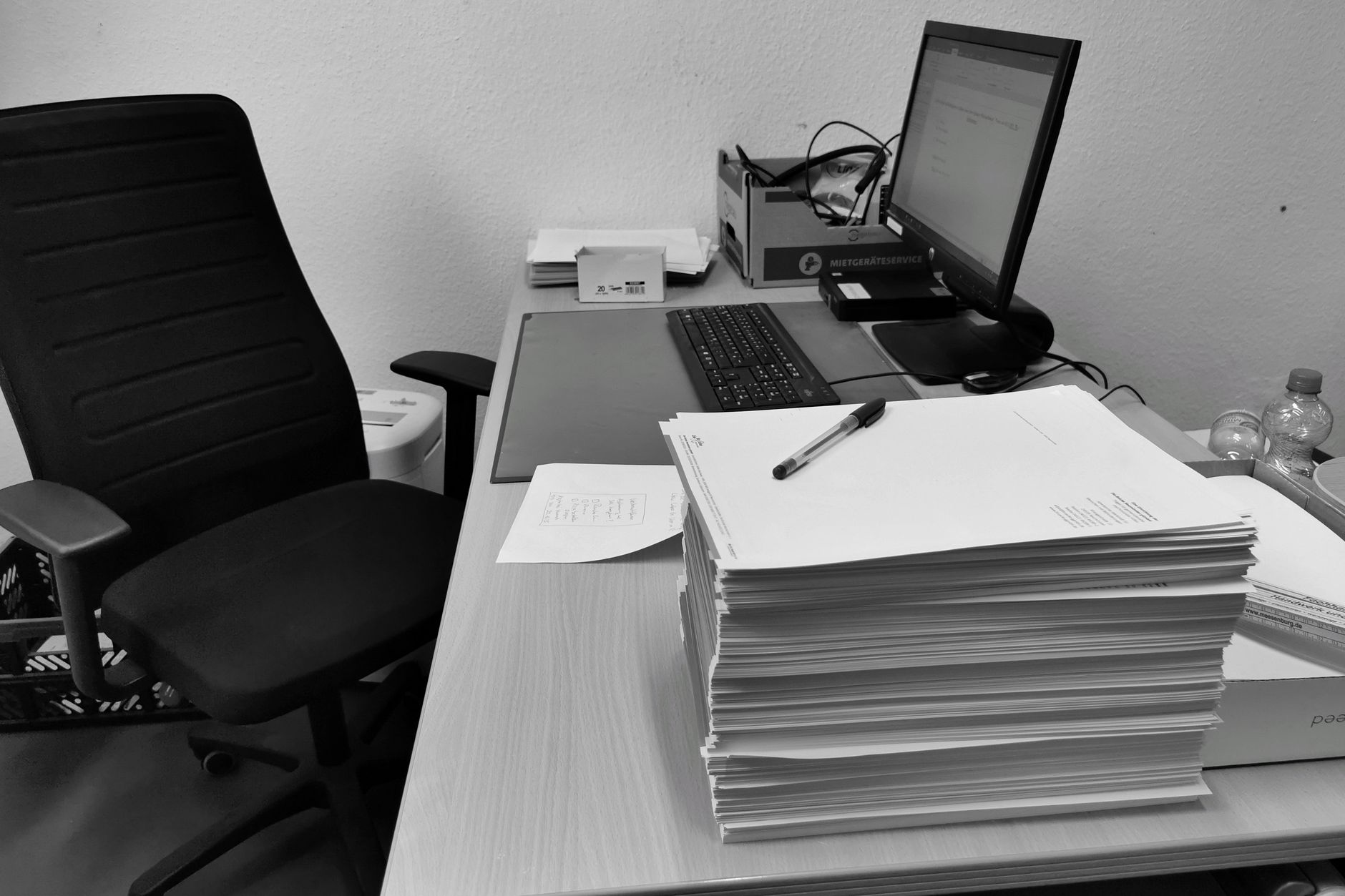 An office desk with documents and a computer, representing resume formatting